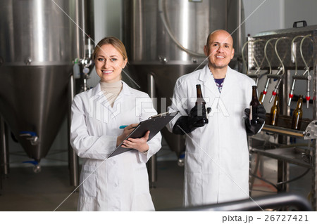 Girl and man in modern beer production facility Girl and man in modern beer production facility 26727421