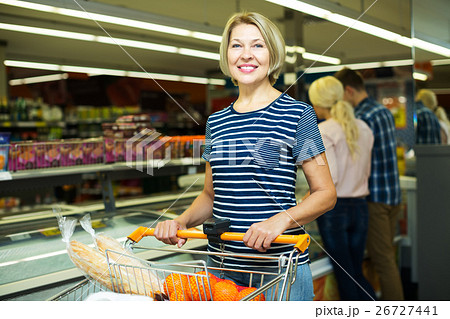 Woman buying frozen vegetables 26727441