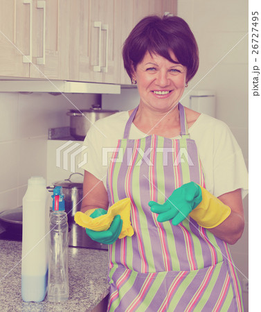 retiree woman cleaning home retiree woman cleaning home 26727495