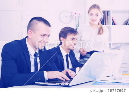 Coworkers working on document paper 26727697