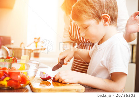 Small boy cooking together with his mother 26736303