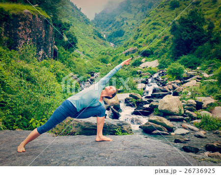 Woman practices yoga asana Utthita Parsvakonasana 26736925
