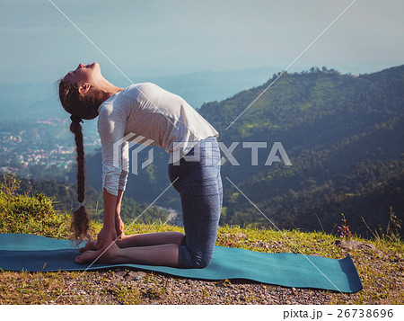 Woman doing yoga asana Ustrasana camel pose Woman doing yoga asana Ustrasana camel pose 26738696
