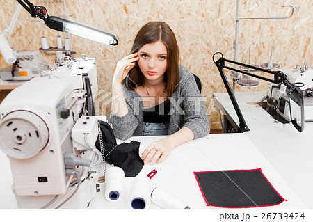 Bored seamstress looking at camera, free space 26739424