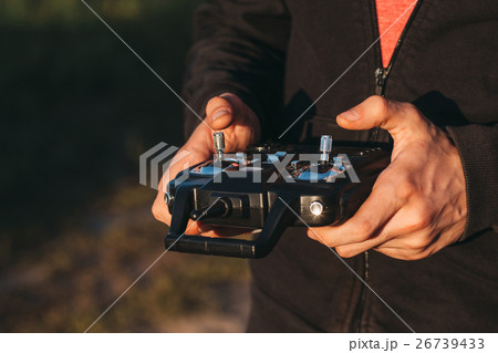 Man holding remote controller in hands close-up 26739433