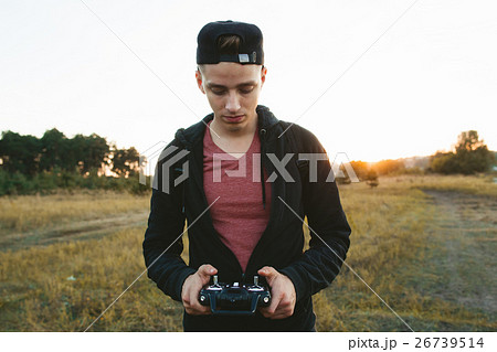 Serious man with remote controller portrait 26739514