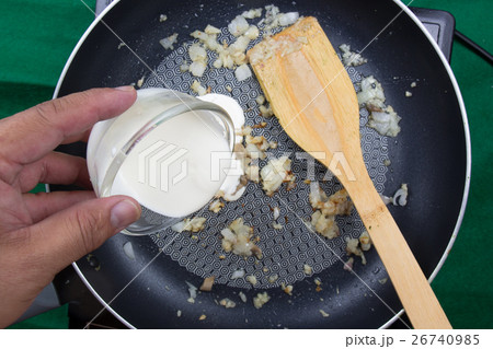 Chef pouring Whipping cream to the pan  26740985