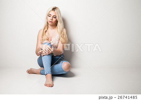 Young blonde sitting on studio 26741485