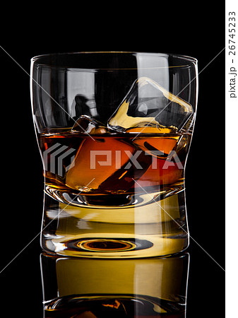 Glass of whiskey with golden ice cubes reflection Glass of whiskey with golden ice cubes reflection 26745233