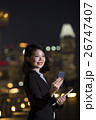 Asian businesswoman using her smart phone in city at night. 26747407
