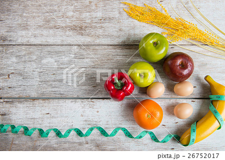 Measuring tape on fruits. Symbol of diet. 26752017