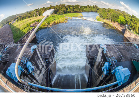 Water flowing from the open sluice gates of dam. 26753960