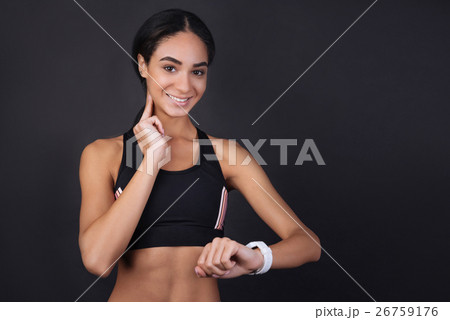 Cute girl measuring her pulse using smart watches Cute girl measuring her pulse using smart watches 26759176