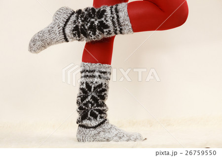 Woman legs wearing woolen socks and red tights Woman legs wearing woolen socks and red tights 26759550