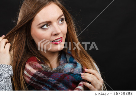 Smiling girl wearing warm wooden scarf 26759898
