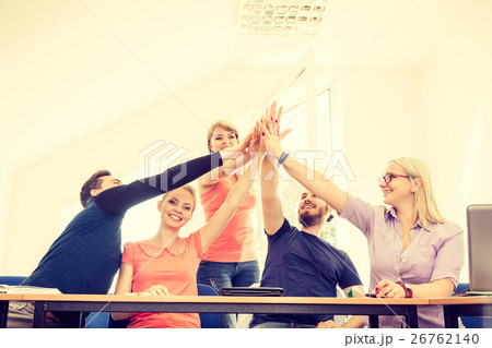 team of friends showing unity with their hands together team of friends showing unity with their hands together 26762140