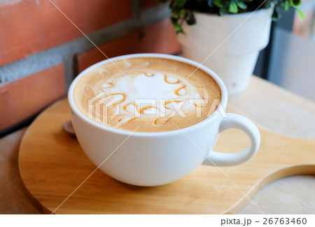 caramel coffee in white cup on wood table 26763460