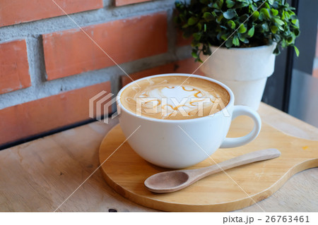 caramel coffee in white cup on wood table 26763461