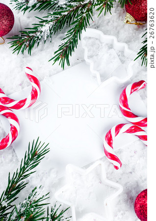 Clear paper laying with candy cane. 26763620