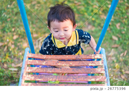 Asian kid goes up the stairs in the park. 26775396