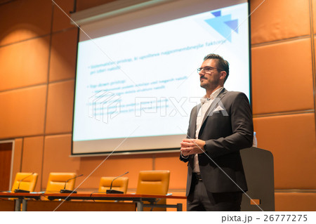 Speaker giving talk on podium at Business 26777275