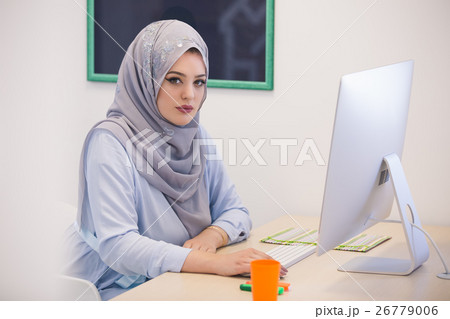 Attractive Muslim young woman working in office on 26779006