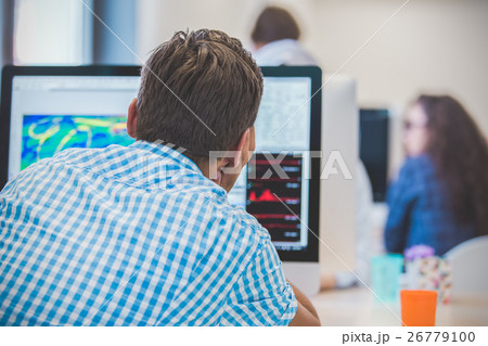 Thoughtful young programmer coding on computer 26779100