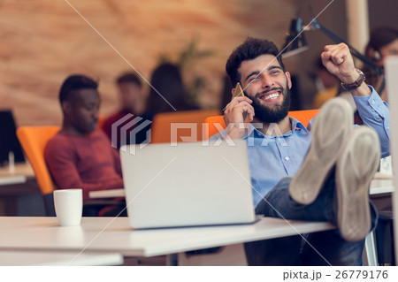 Relaxed businessman at workplace at early morning Relaxed businessman at workplace at early morning 26779176