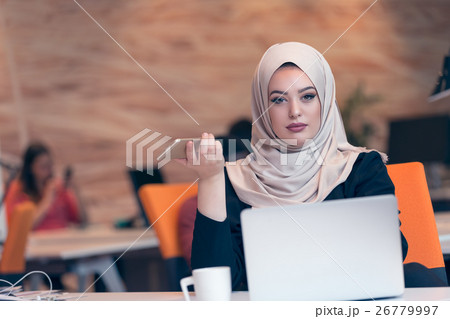 Arabic business woman wearing hijab,working in 26779997