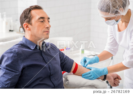 Male patient getting collecting analysis in clinic 26782169