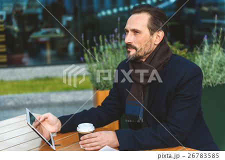 Businessman using gadget on break 26783585