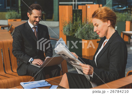 Cheerful colleagues entertaining in restaurant 26784210