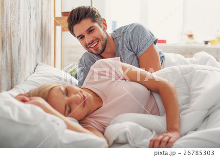 Happy man watching her wife sleeping Happy man watching her wife sleeping 26785303