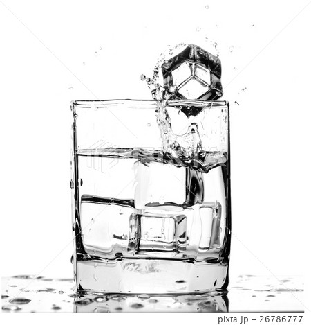 Ice cube splashing in a cool glass of water Ice cube splashing in a cool glass of water 26786777