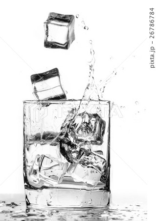 Ice cube splashing in a cool glass of water 26786784