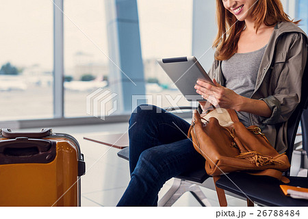 Beautiful girl using tablet in airport Beautiful girl using tablet in airport 26788484