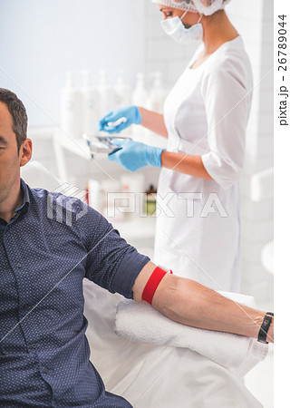 Male patient waiting for blood sampling 26789044