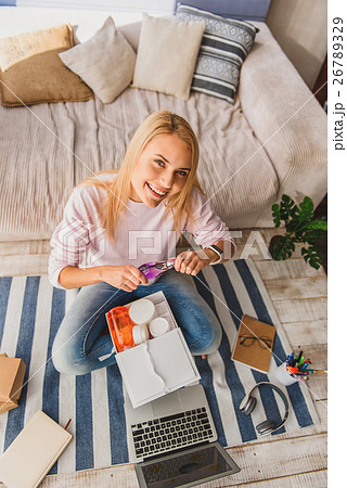 Happy girl entertaining with cosmetic products Happy girl entertaining with cosmetic products 26789329