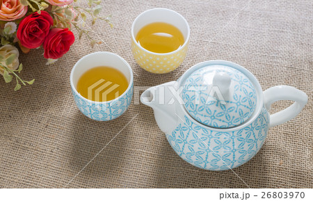 hot green tea and tea pot on sackcloth. hot green tea and tea pot on sackcloth. 26803970