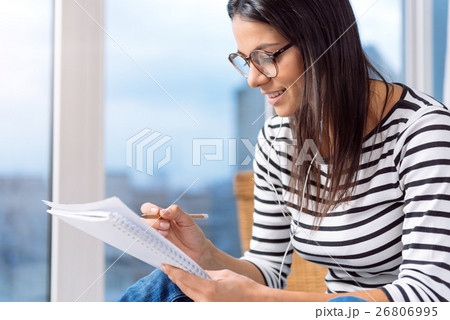 Delighted young woman drawing in the studio 26806995
