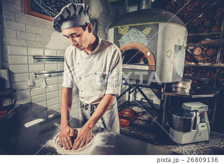 Young chef preparing dough Young chef preparing dough 26809136