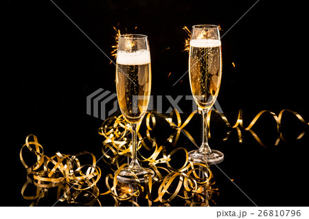 Glasses with champagne against holiday lights 26810796