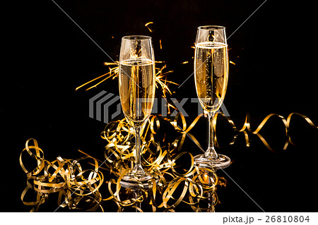 Glasses with champagne against holiday lights 26810804