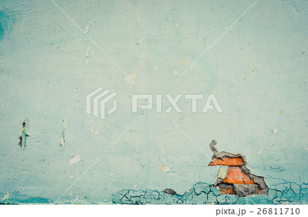 Wall with peeling paint and exposed bricks.  26811710