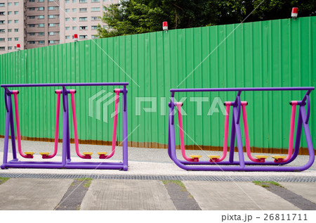 Colorful exercise equipment in a park.  26811711