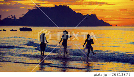 Silhouette of two girls at sunset in the backgroun 26813375