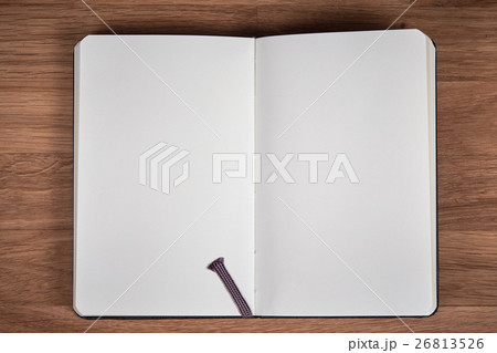 White pages of open notebook on a wooden table White pages of open notebook on a wooden table 26813526
