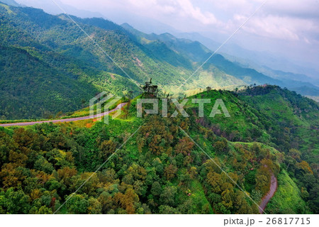 Aerial view over mountain road going through fores Aerial view over mountain road going through fores 26817715