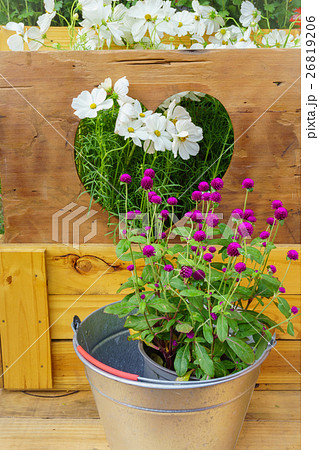 The flowers in vase on wooden background. The flowers in vase on wooden background. 26819206