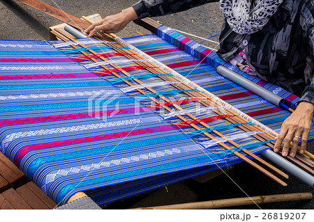 Hand of the woman weaves traditional fabric. 26819207